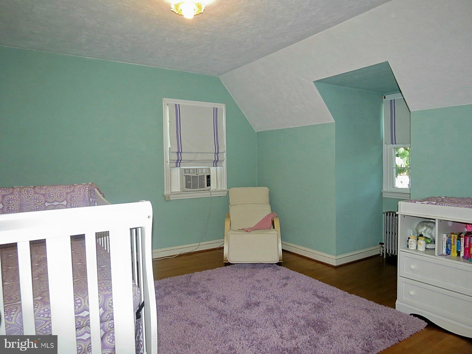 502 North Main Street Mount Airy, MD 21771 - Photo 25 of 27 a living room with a baby crib furniture and a wooden floor