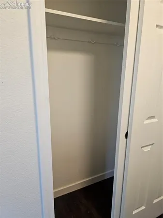 a bathroom with a granite countertop sink toilet and mirror