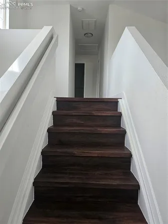 an empty room with wooden floor