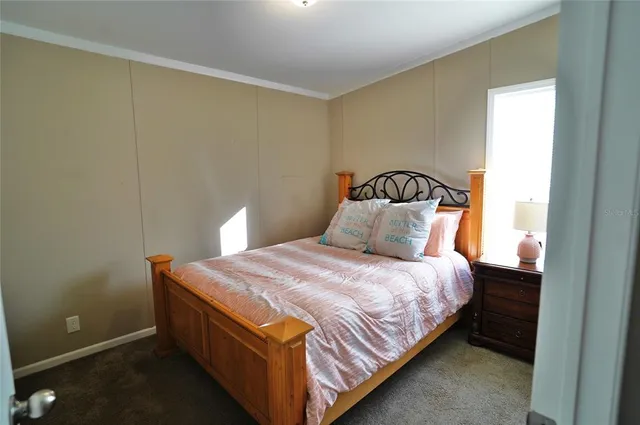 a kitchen with stainless steel appliances granite countertop a refrigerator a stove and a sink with wooden floor