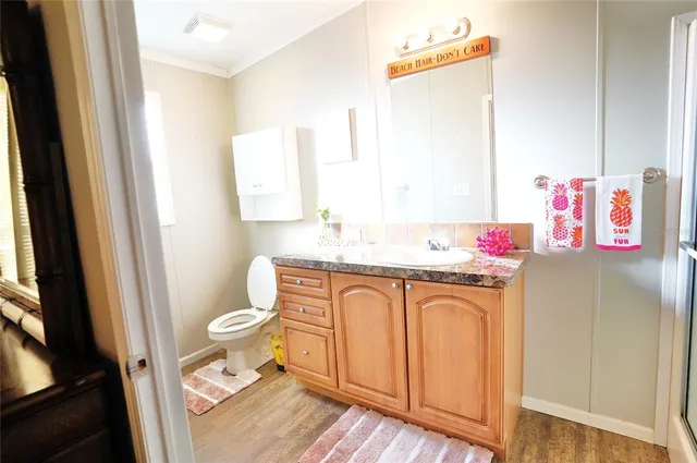 an aerial view of a house with a yard and a large tree