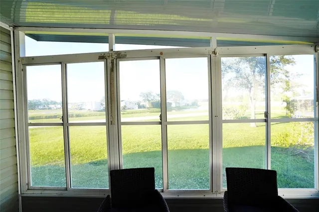 a view of a patio with a table and chairs under an umbrella