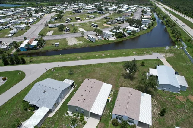 an aerial view of a house with swimming pool and lake view