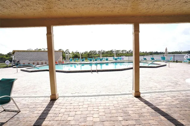 a view of a tables and chairs under an umbrella