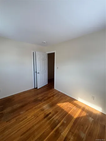 a view of an empty room and wooden floor