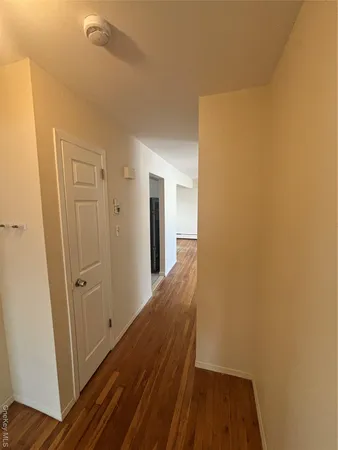 a view of hallway with wooden floor