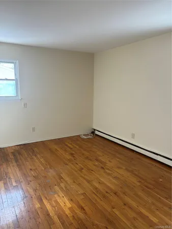 an empty room with wooden floor
