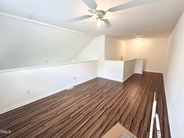 a view of a room with wooden floor