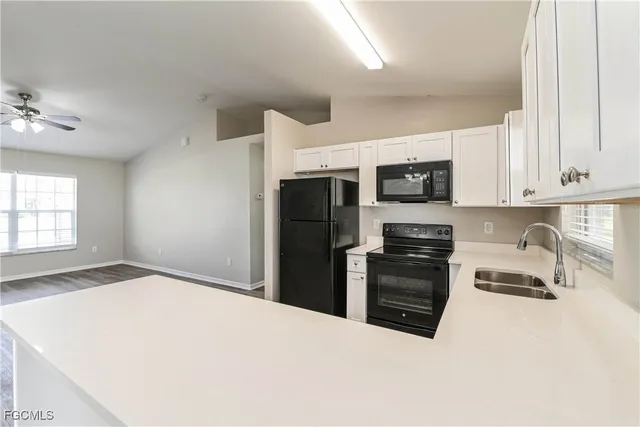 a kitchen with stainless steel appliances a stove microwave and refrigerator