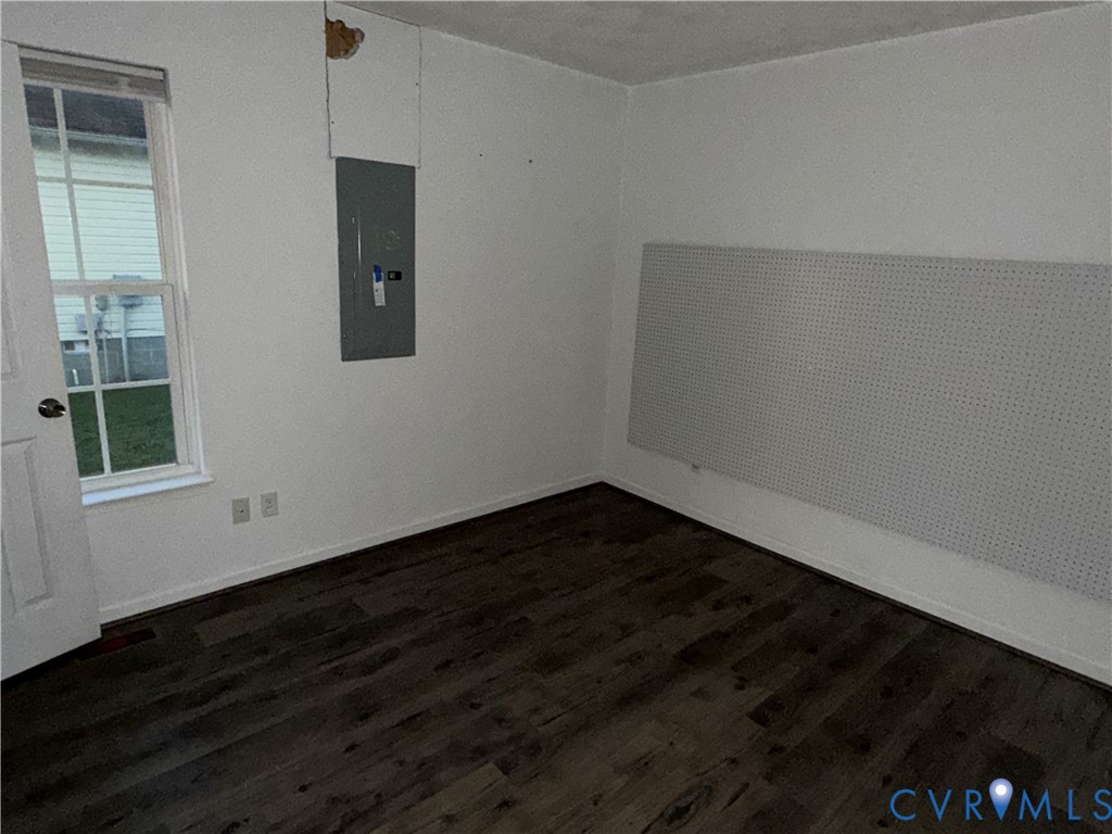 117 Pleasant Spring Avenue Waverly, VA 23890 - Photo 8 of 12 a view of an empty room with wooden floor and a window