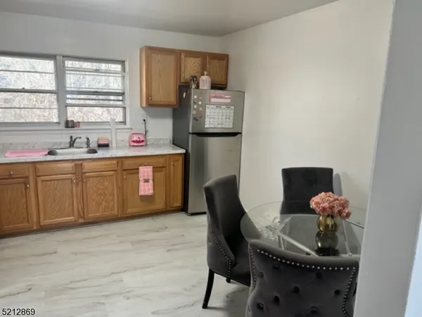 a kitchen with a chair and a refrigerator