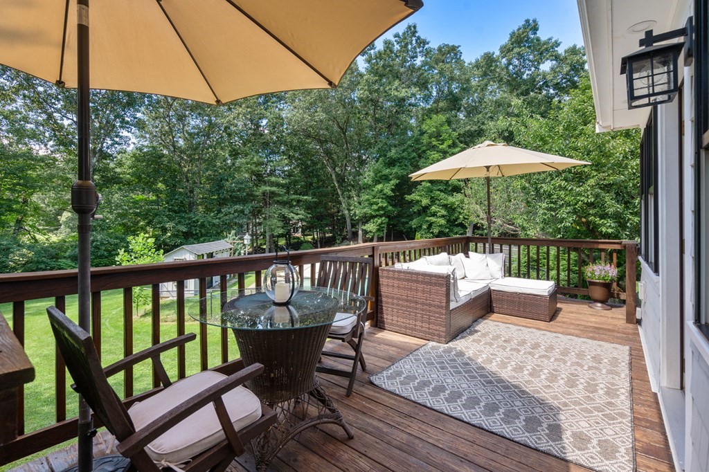 39 Bradyll Road Weston, MA 02493 - Photo 3 of 11 a view of a two chairs and table in the deck