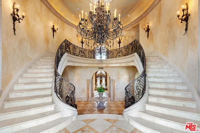 a living room with couches a dining table and chairs with wooden floor