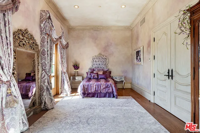 a bedroom with a bed and a painting on the wall