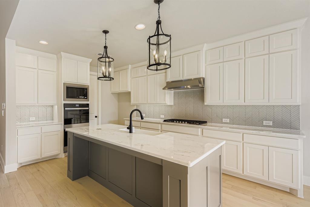 4446 Timberdrift Street Midlothian, TX 76065 - Photo 13 of 28 a kitchen with a sink a counter space appliances and cabinets