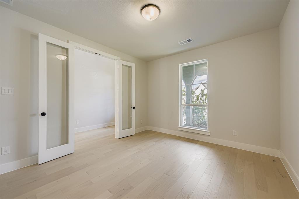 4446 Timberdrift Street Midlothian, TX 76065 - Photo 14 of 28 an empty room with wooden floor and windows