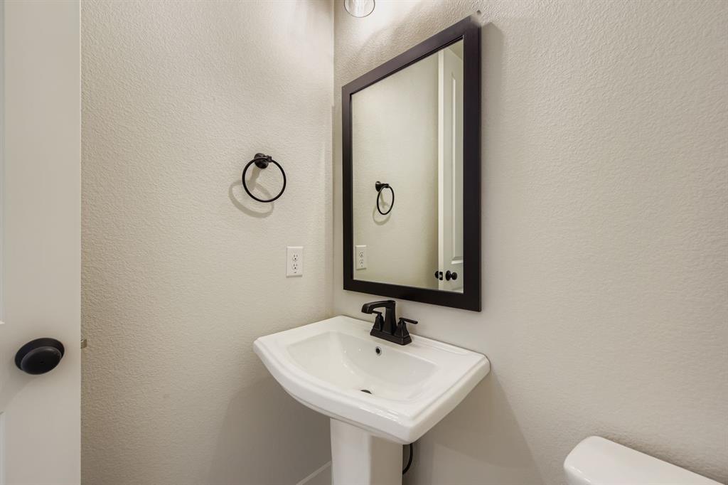 4446 Timberdrift Street Midlothian, TX 76065 - Photo 15 of 28 a bathroom with a toilet sink and mirror