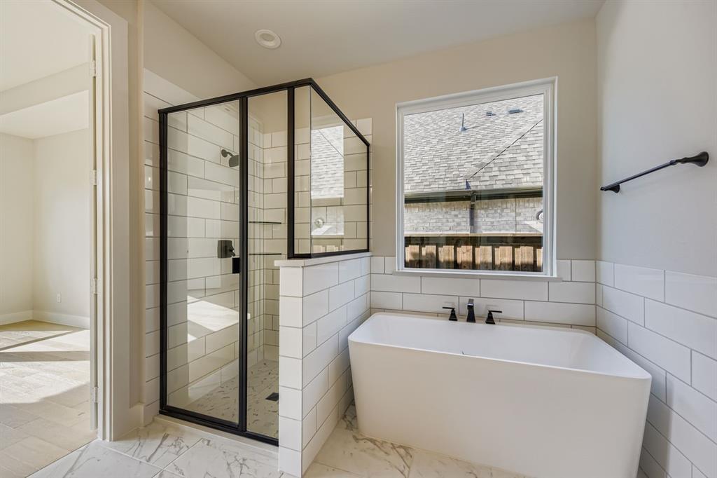4446 Timberdrift Street Midlothian, TX 76065 - Photo 18 of 28 a bathroom with a bathtub and a shower