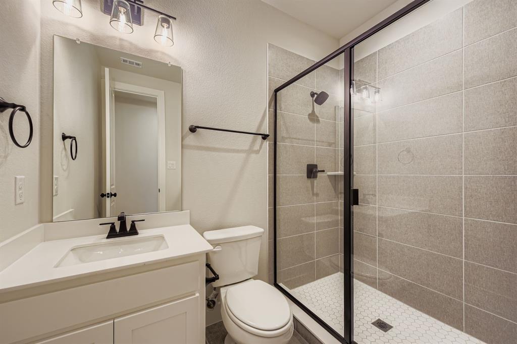 4446 Timberdrift Street Midlothian, TX 76065 - Photo 21 of 28 a bathroom with a sink a toilet and shower