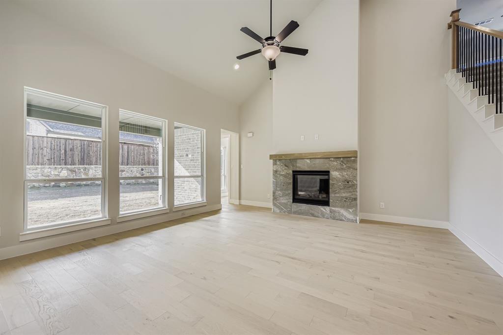 4446 Timberdrift Street Midlothian, TX 76065 - Photo 5 of 28 a view of an empty room with a fireplace and a window