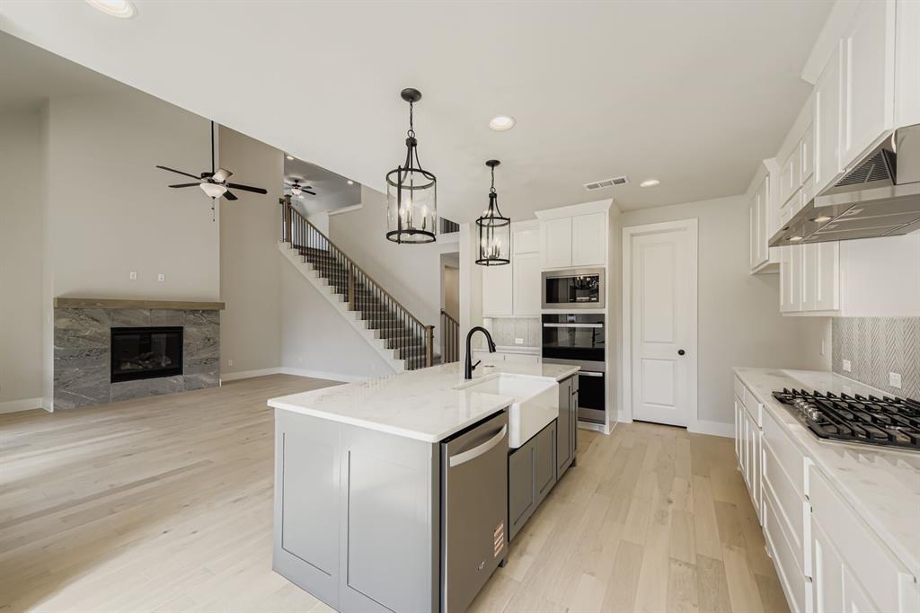 4446 Timberdrift Street Midlothian, TX 76065 - Photo 9 of 28 a open kitchen with a sink appliances and cabinets
