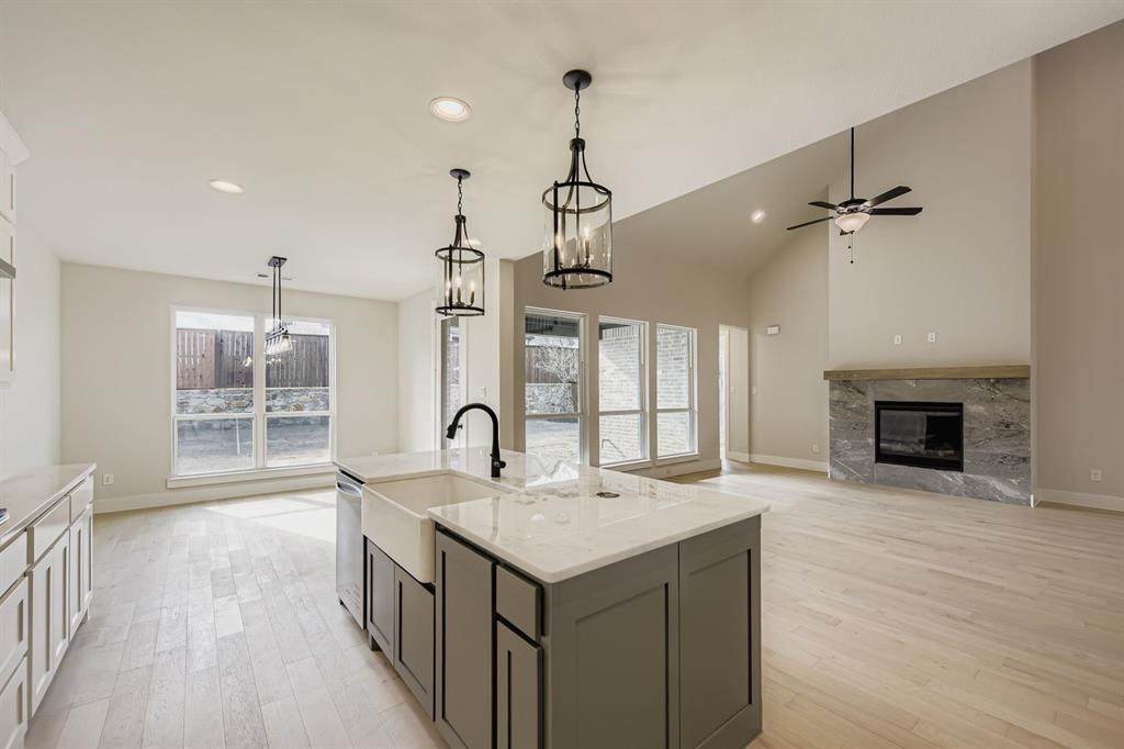 4446 Timberdrift Street Midlothian, TX 76065 - Photo 10 of 28 a kitchen with a sink chandelier and wooden floor