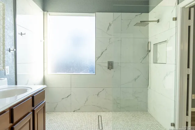 a bathroom with a bathtub and shower