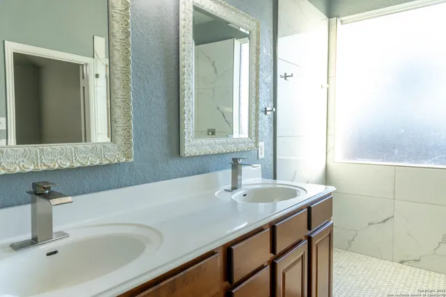 a bathroom with a sink and a mirror