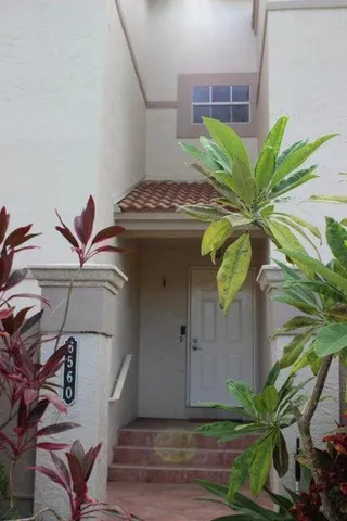 a kitchen with granite countertop a stove a sink and a refrigerator