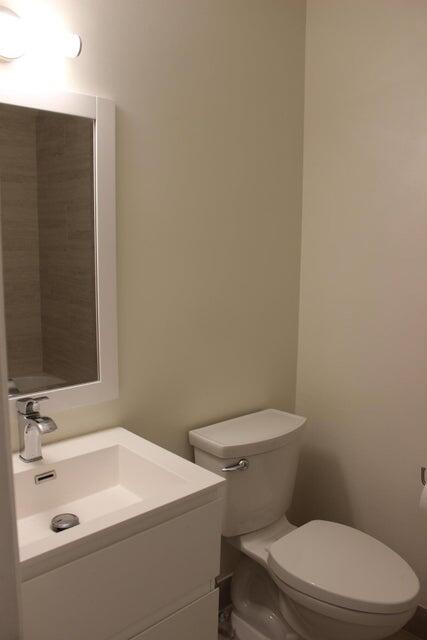 6560 Via Regina Boca Raton, FL 33433 - Photo 4 of 15 a white toilet sitting next to a bathroom sink