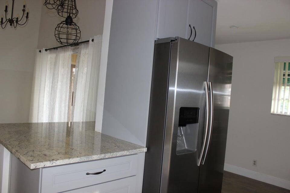6560 Via Regina Boca Raton, FL 33433 - Photo 7 of 15 a kitchen with a refrigerator and countertop