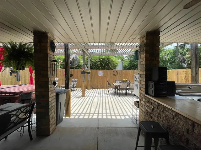 a view of a patio with table and chairs and wooden floor