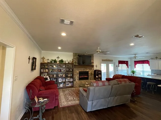 a living room with furniture a fireplace and a flat screen tv