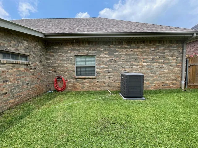 a view of yard from deck with patio