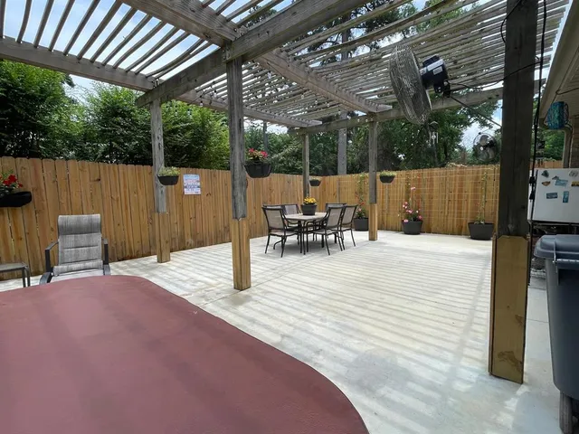 a view of a patio with table and chairs a flat screen tv