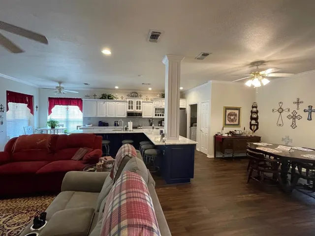 a living room with furniture and kitchen view