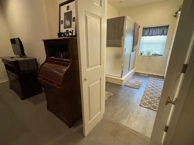 a bathroom with a double vanity sink mirror and shower