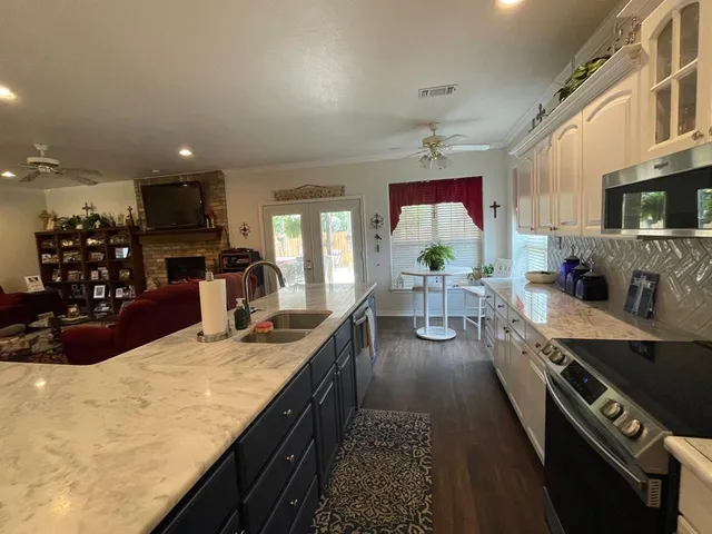 a kitchen with stainless steel appliances granite countertop a stove and a sink