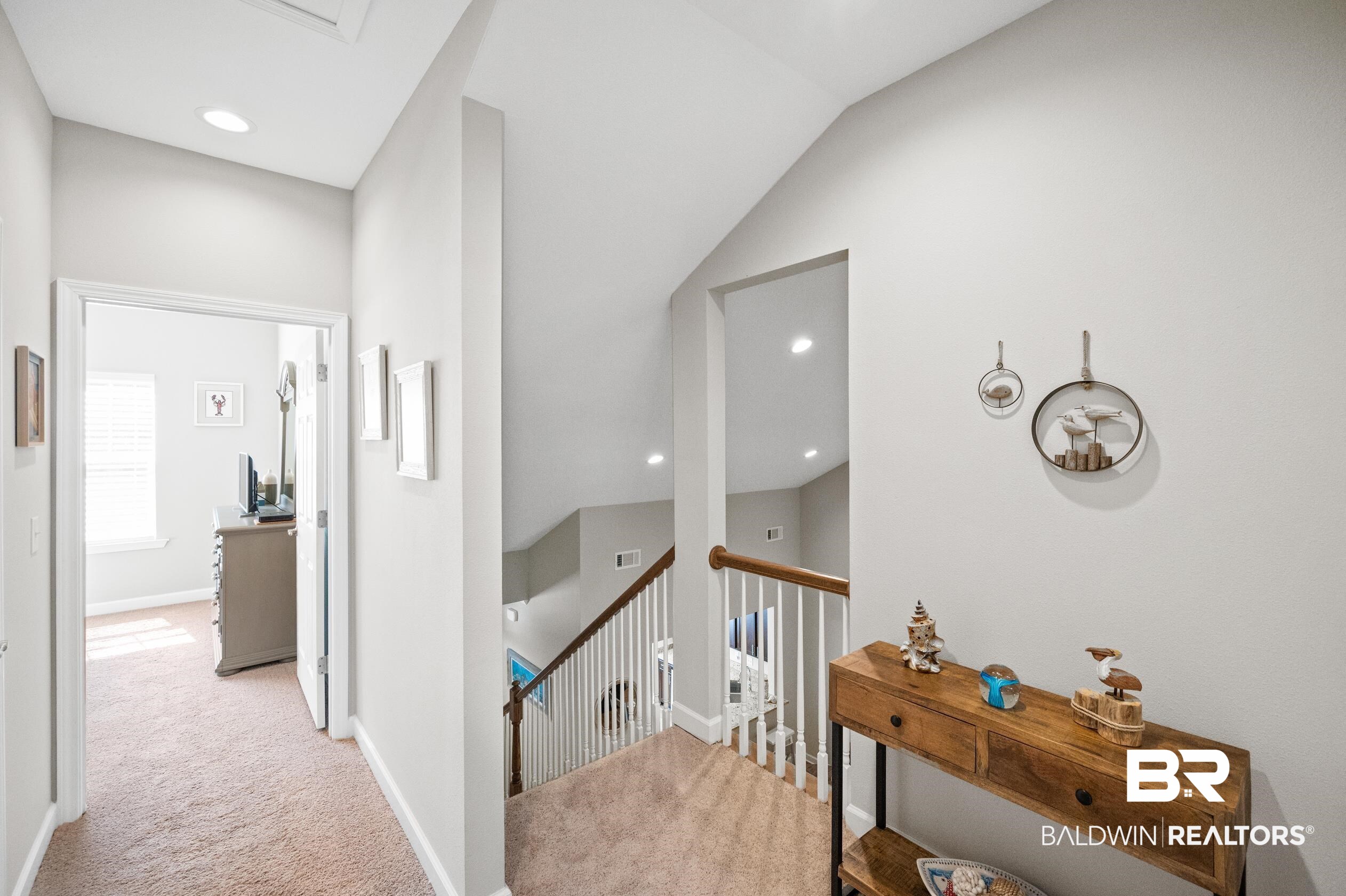 430 West Fort Morgan Road, Unit 1902 Gulf Shores, AL 36542 - Photo 26 of 59 Corridor featuring light carpet and vaulted ceiling