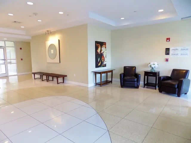 a lobby with furniture and air hockey table