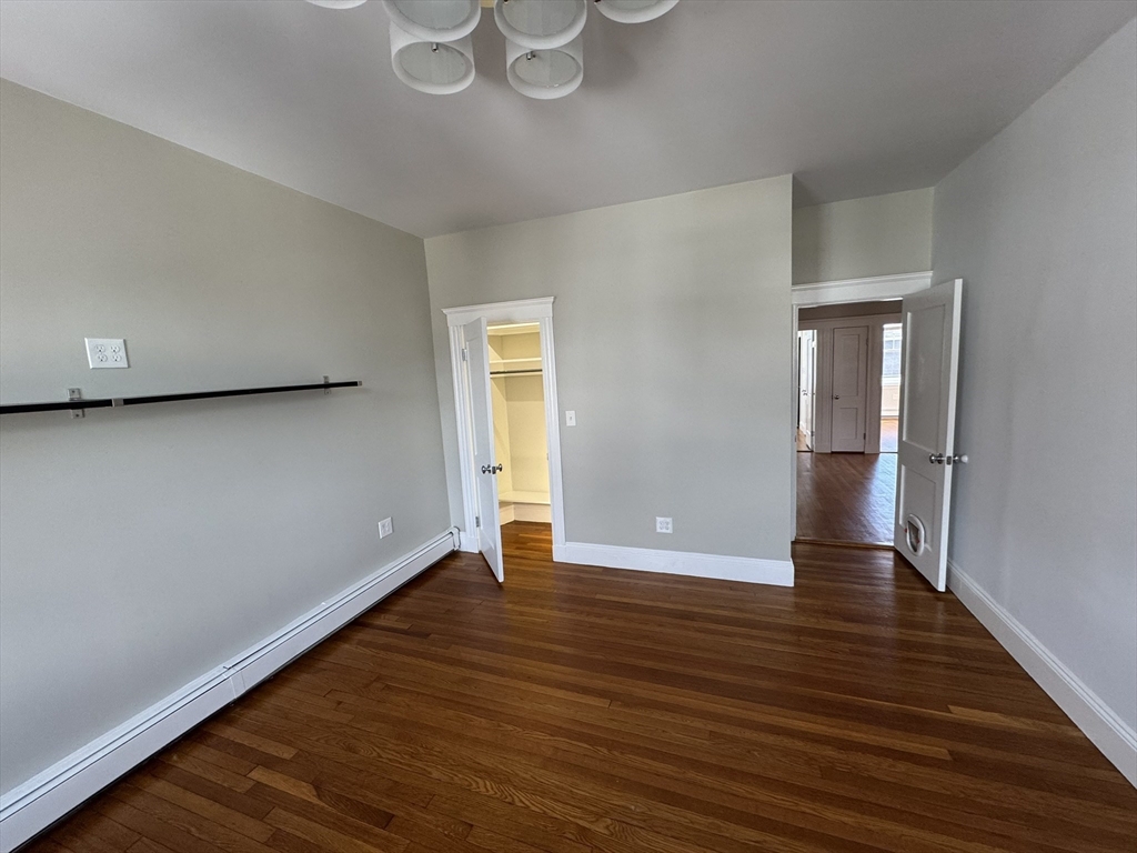 84 Tudor Street, Unit 6 Chelsea, MA 02150 - Photo 12 of 14 a view of an empty room with wooden floor and a window