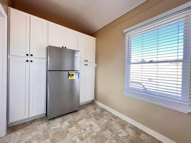 a view of a kitchen with a refrigerator and a window