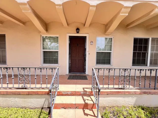 a view of a balcony with two chairs and a table