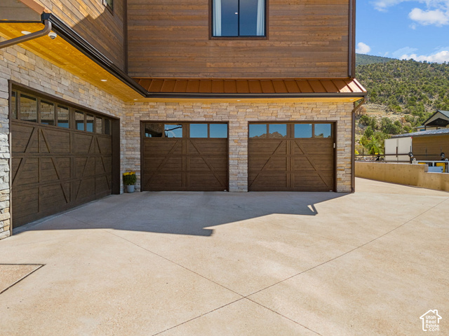1192 East Ashdown Road Cedar City, UT 84721 - Photo 8 of 96 Stone veneer and wood siding exterior with three garage doors