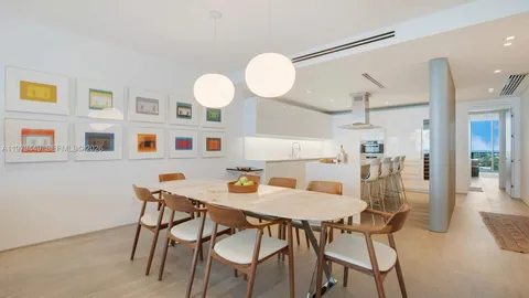 a view of a dining room with furniture and a chandelier fan