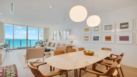 a view of a dining room with furniture large windows and wooden floor