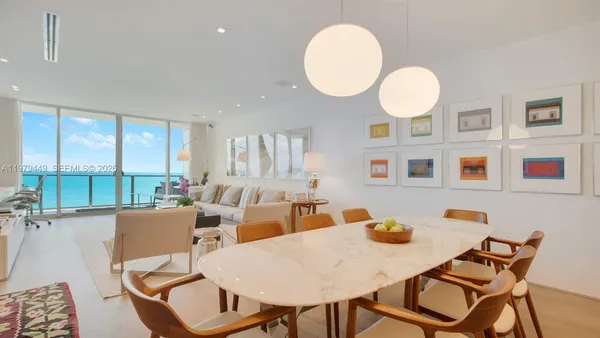 a view of a dining room with furniture large windows and wooden floor