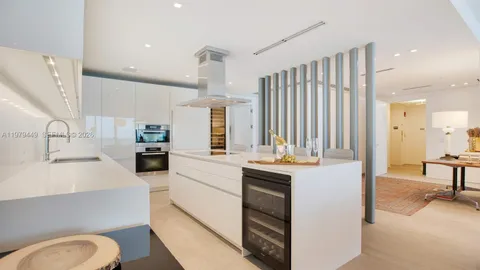 a kitchen with stainless steel appliances kitchen island granite countertop a sink and cabinets
