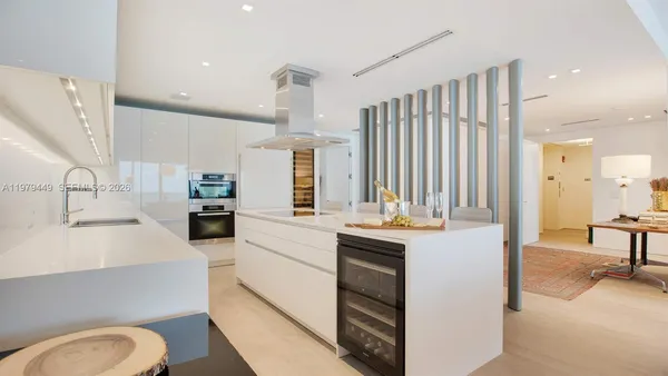 a kitchen with stainless steel appliances kitchen island granite countertop a sink and cabinets