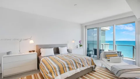 a bedroom with a bed and glass window